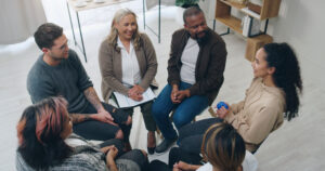 People sitting in a circle talking.