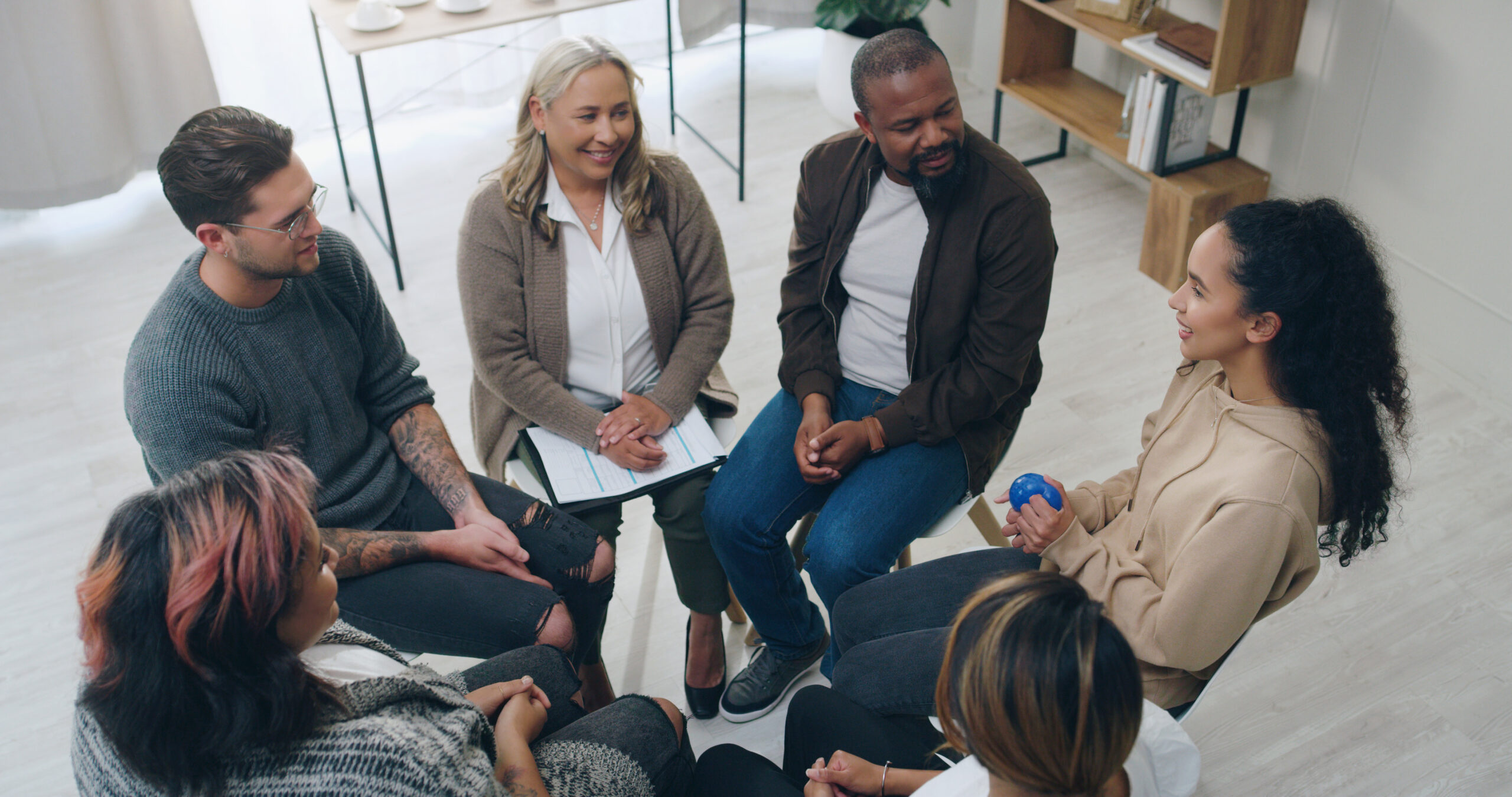 People sitting in a circle talking.